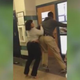 The teacher (left) involved in the incident is held back by a student.
YouTube screenshot